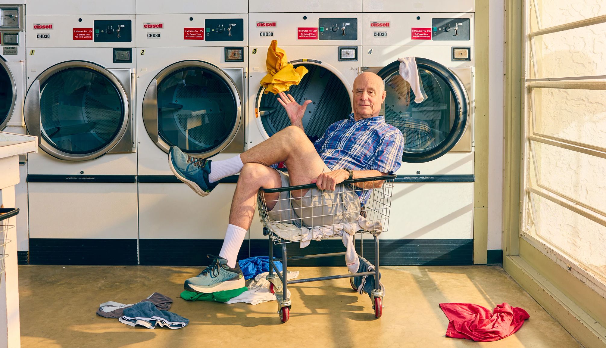 Moving in With My Kid’s Family a man sitting in a cart at a laundromat