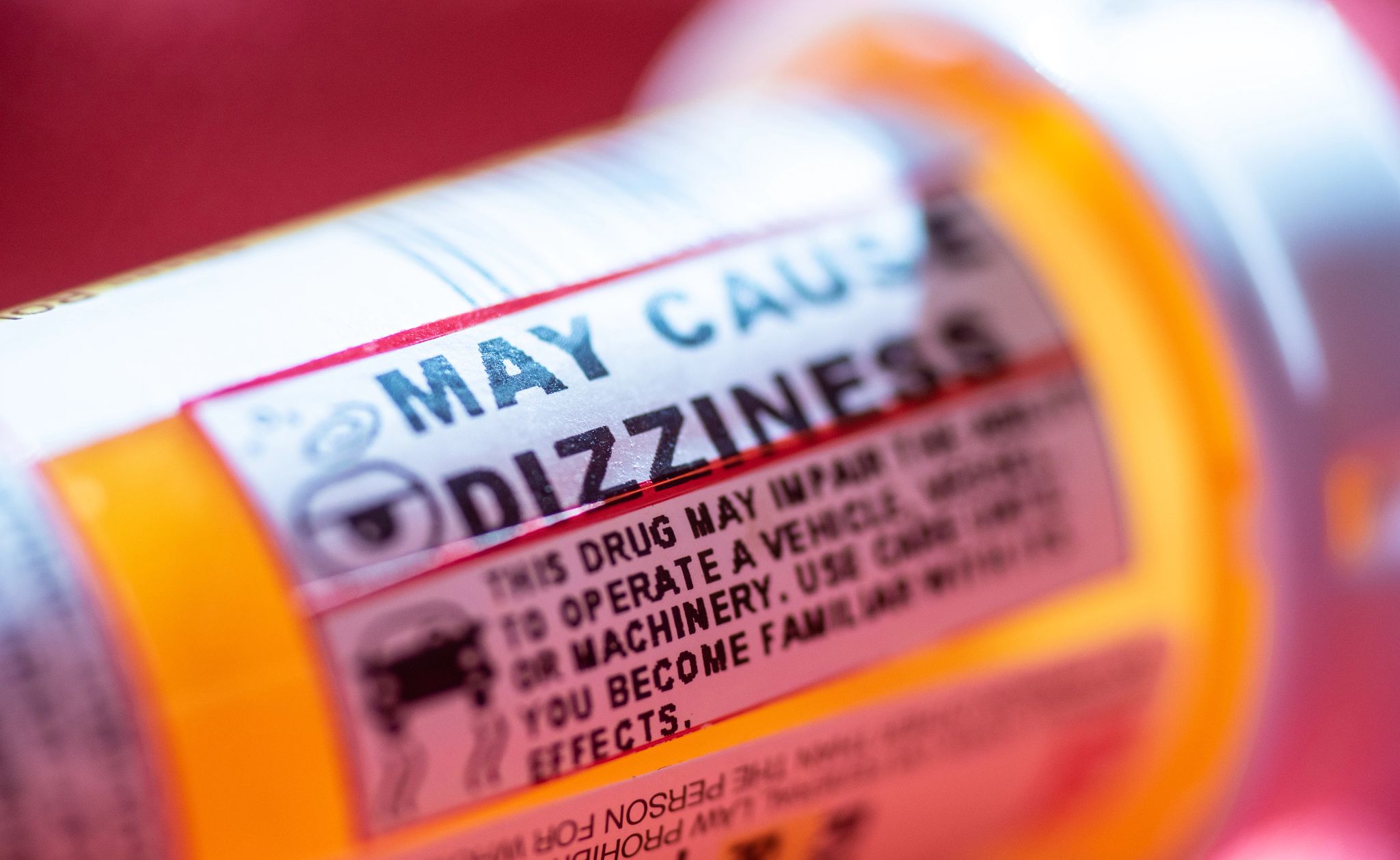 Some high blood pressure medications cause dizzyness close up of a medication pill bottle with a dizzyness warning