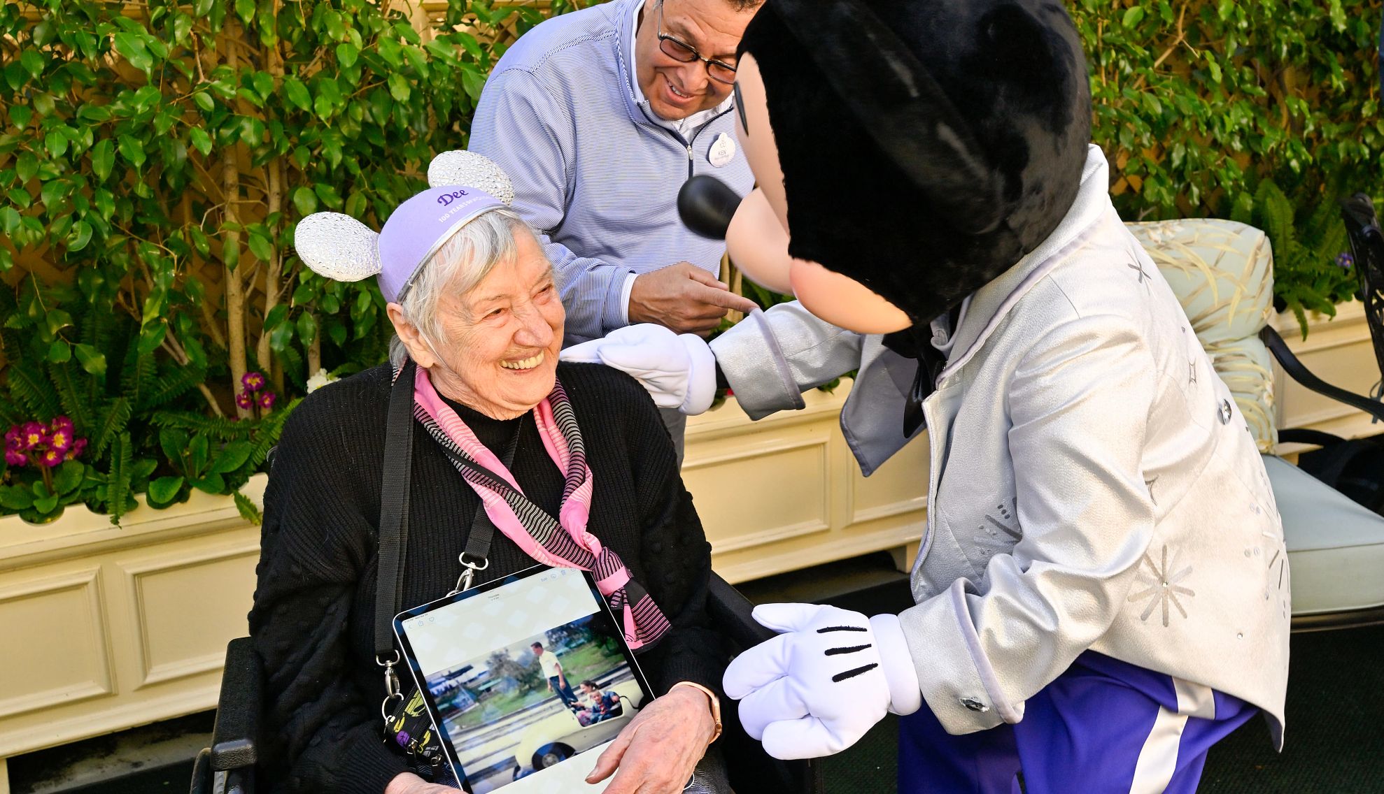 Disney parks offer accessible services Dee Kolafa smiles as she at Mickey Mouse