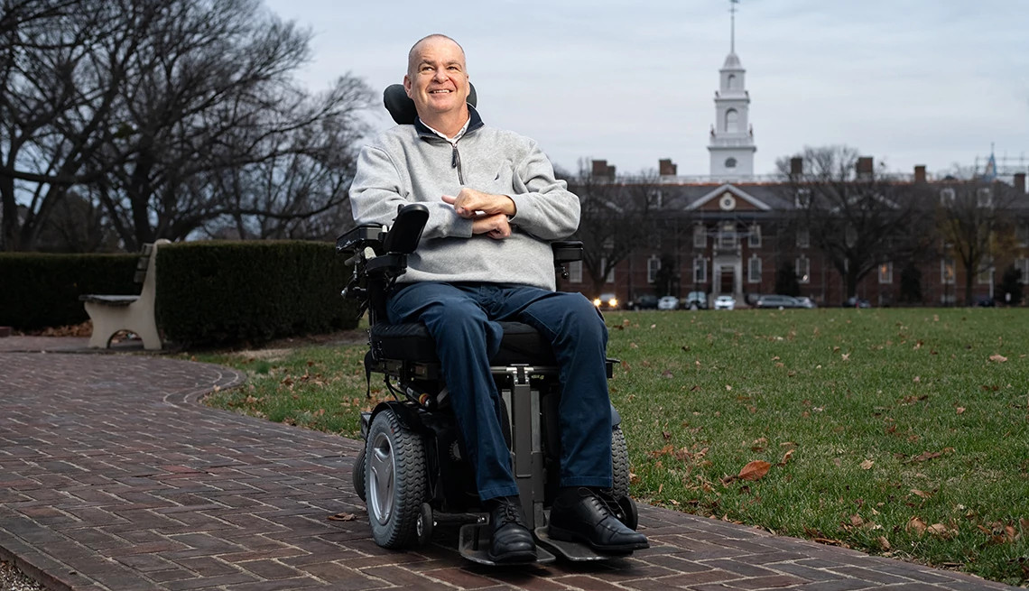 Disabled white male poses for a photo in his motorized wheelchair