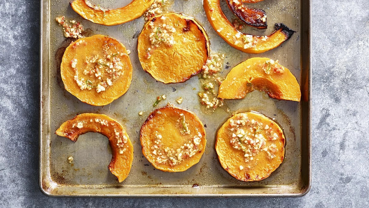 A close-up view of roasted squash with garlic, lime and chile