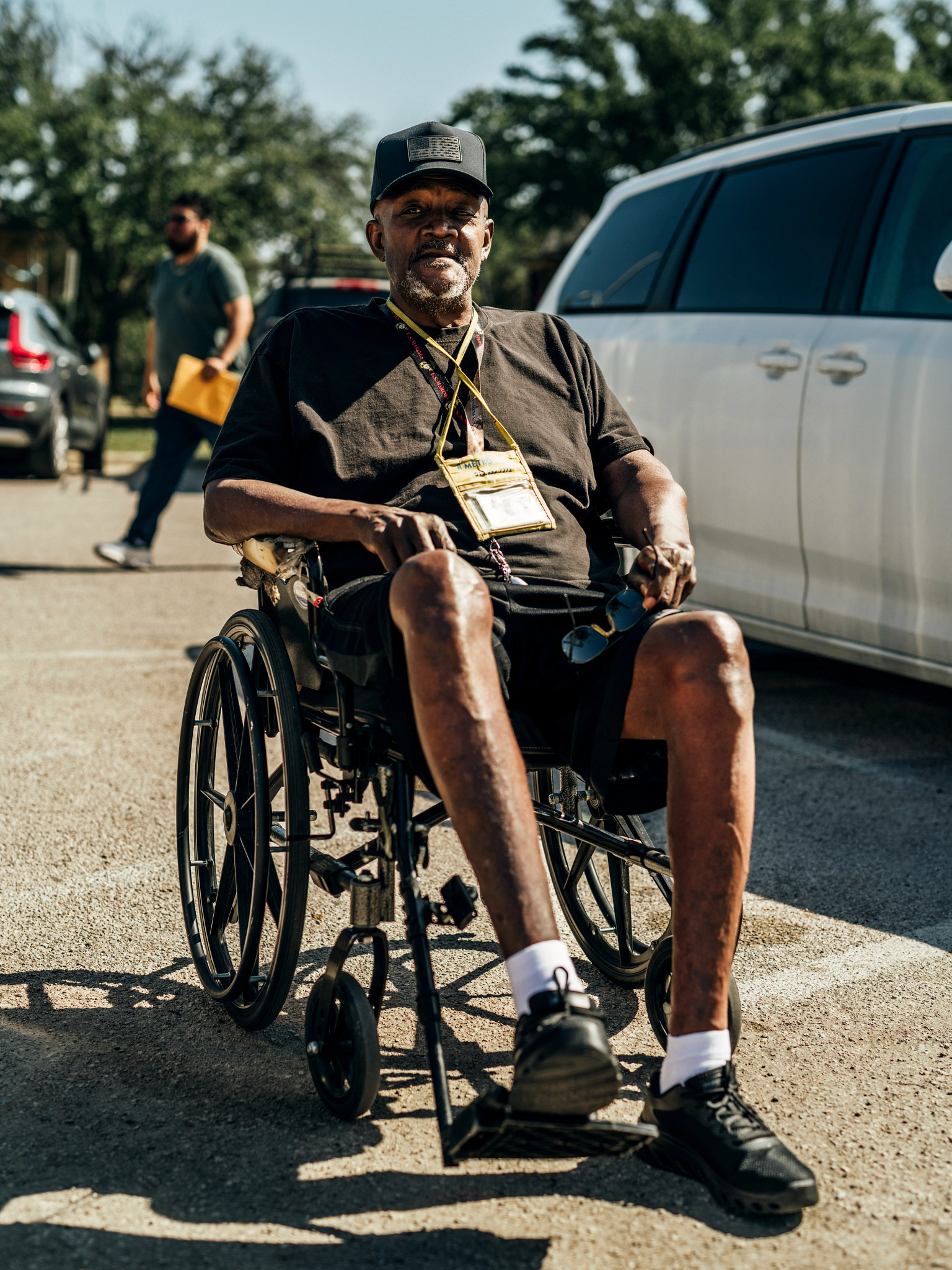 marion clinton sits in a wheelchair outside an office in austin