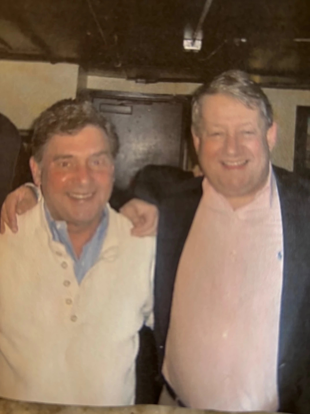 two men smile for the camera