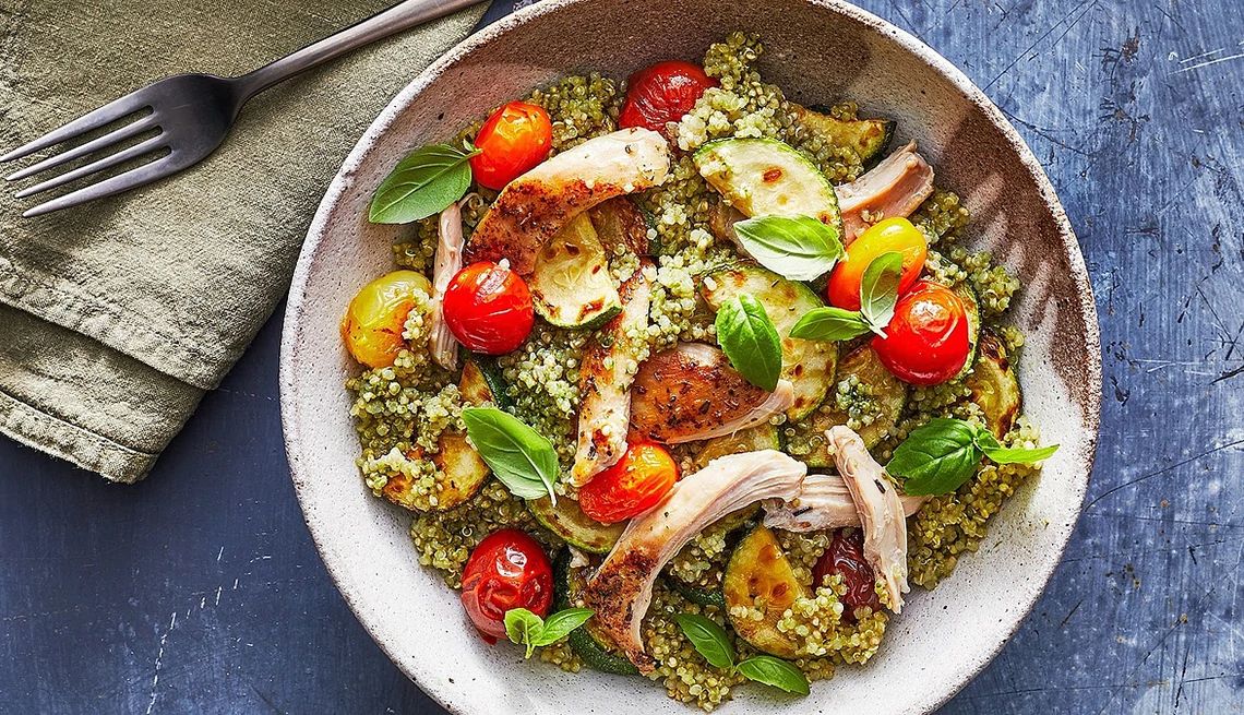 Pesto chicken quinoa bowls A close-up view of a pesto chicken quinoa bowl