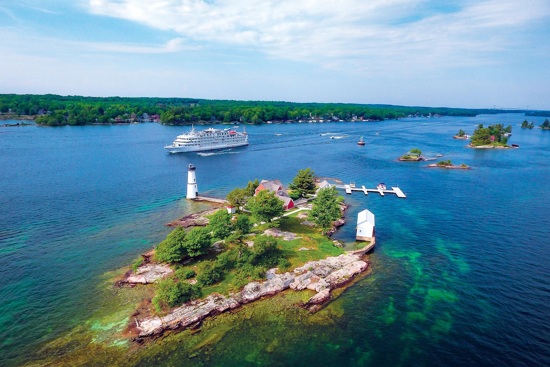 a cruise ship on the lake with a light house