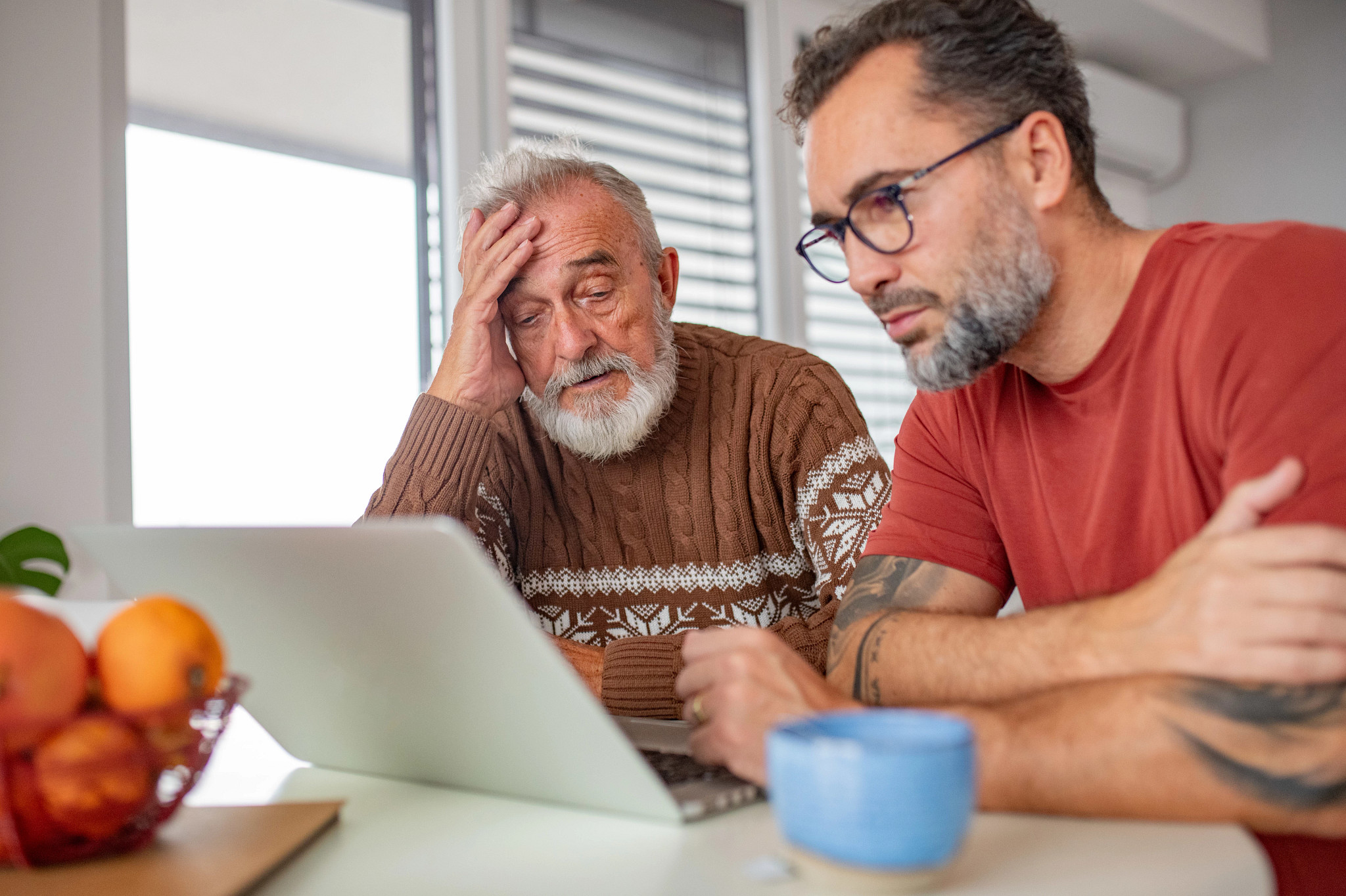 Son explaining father online hoaxs, showing him evidence.