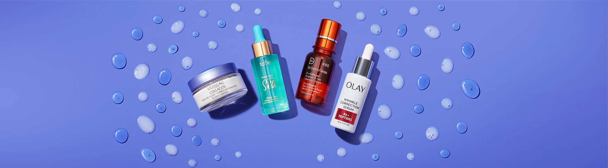 4 Collagen creams photographed on a purple background with droplets around them