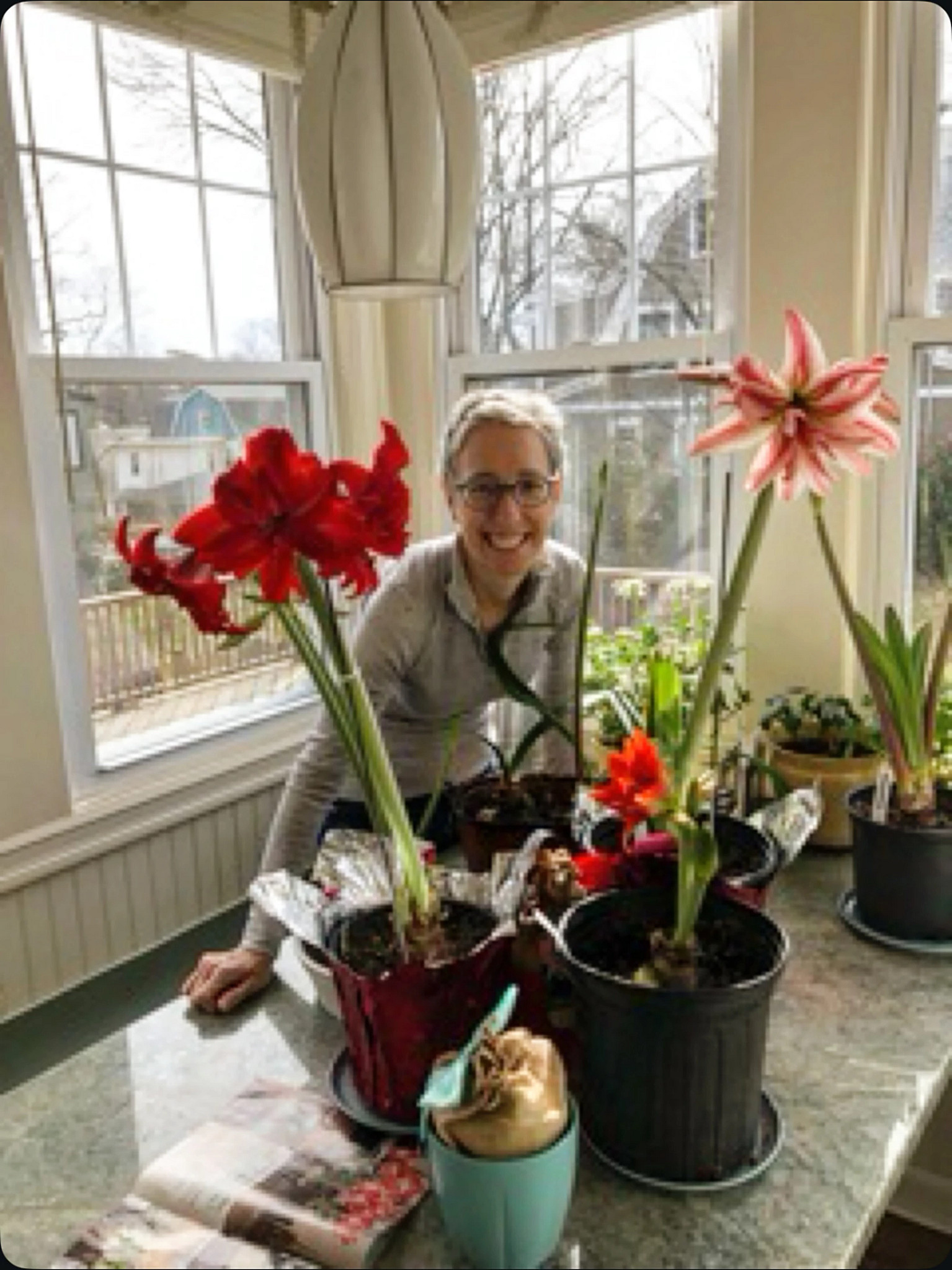 Author Steven Petrow’s sister Julie is shown with her collection of amaryllis plants in a 2021 photo