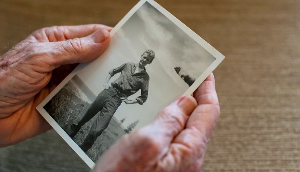 Some older adults have a better memory than others A close up of older hands holding an old photo of a young man