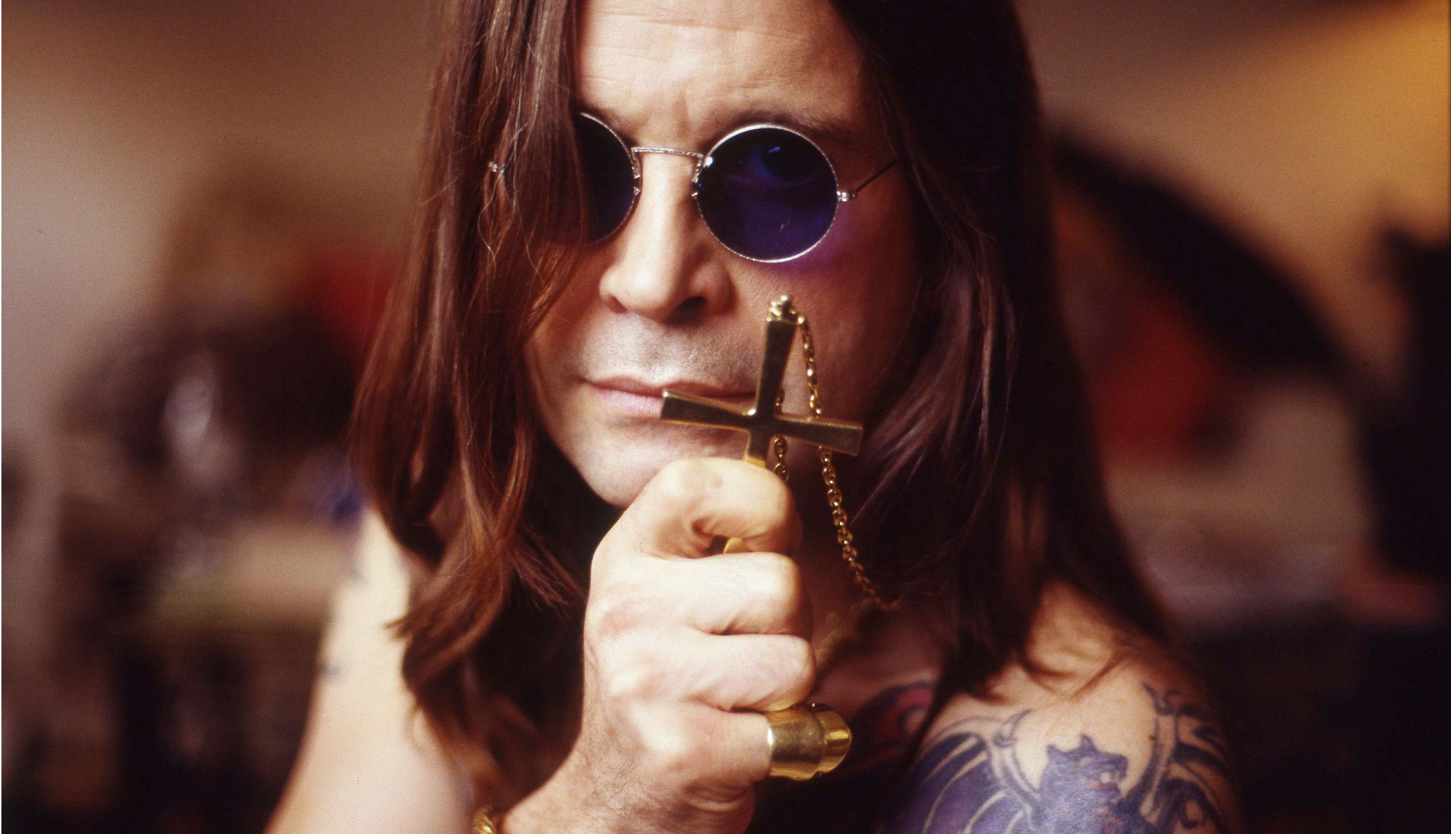 Ozzy Osbourne As I Remember Him ozzy osbourne wearing sunglasses and holding a cross