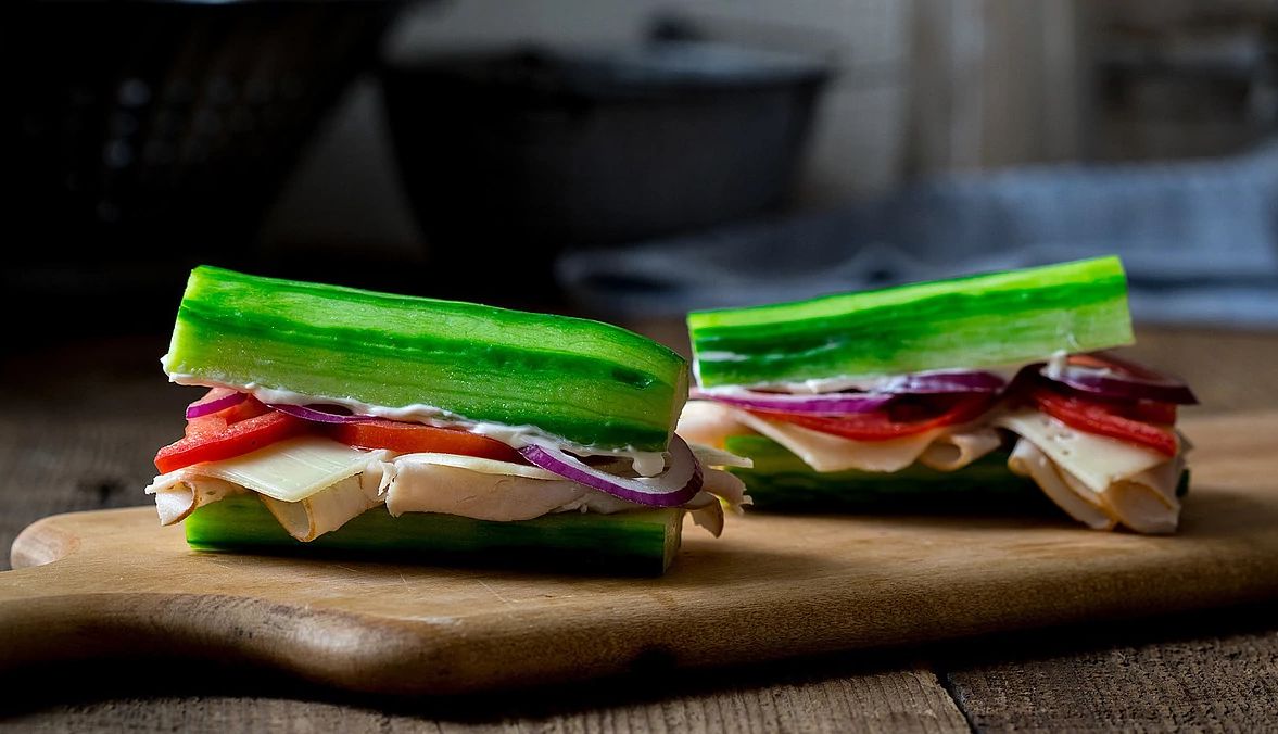 Cucumber turkey sub sandwich A close-up view of a cucumber turkey sub sandwich on a cutting board