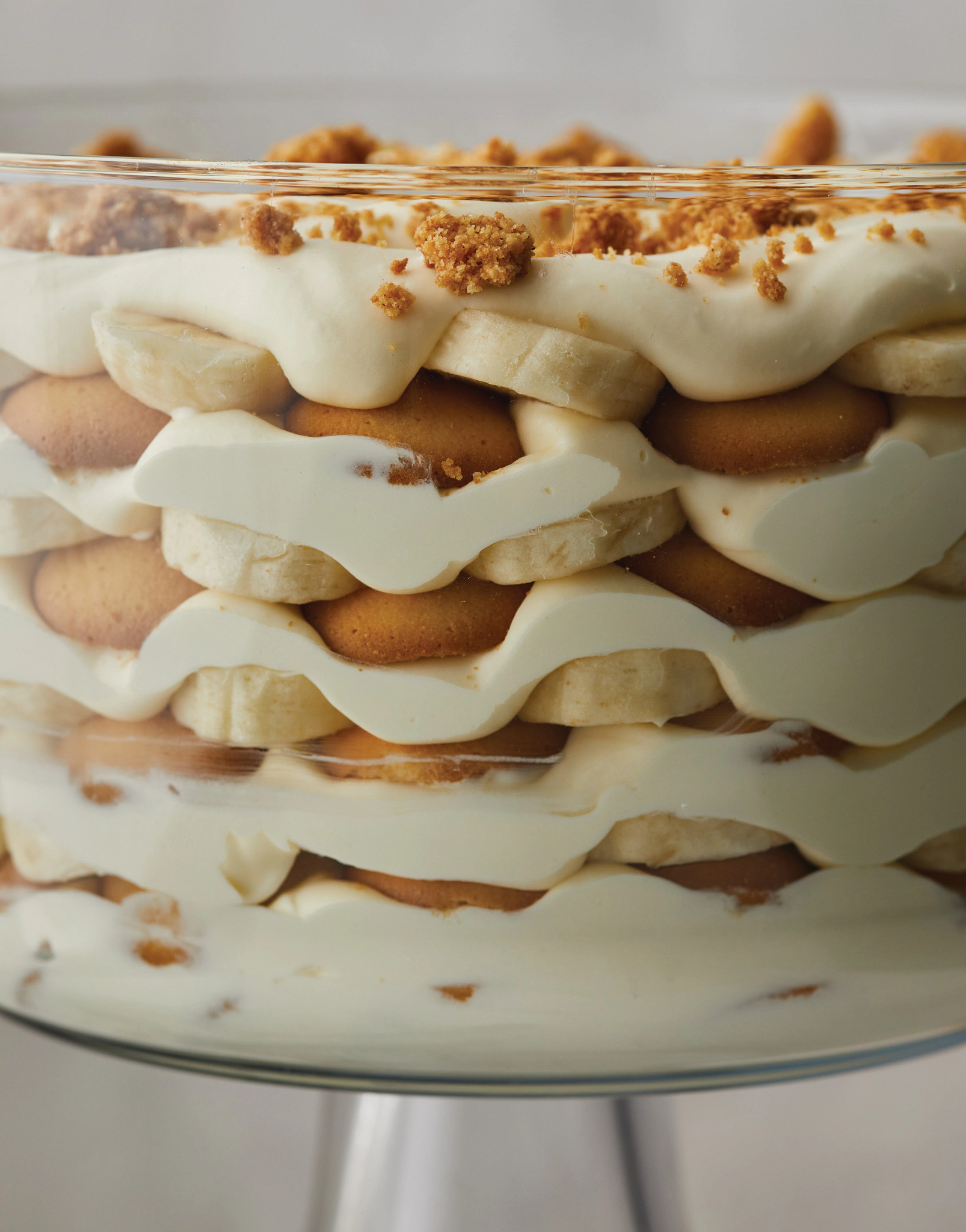 a close-up view of layered banana pudding in a glass bowl