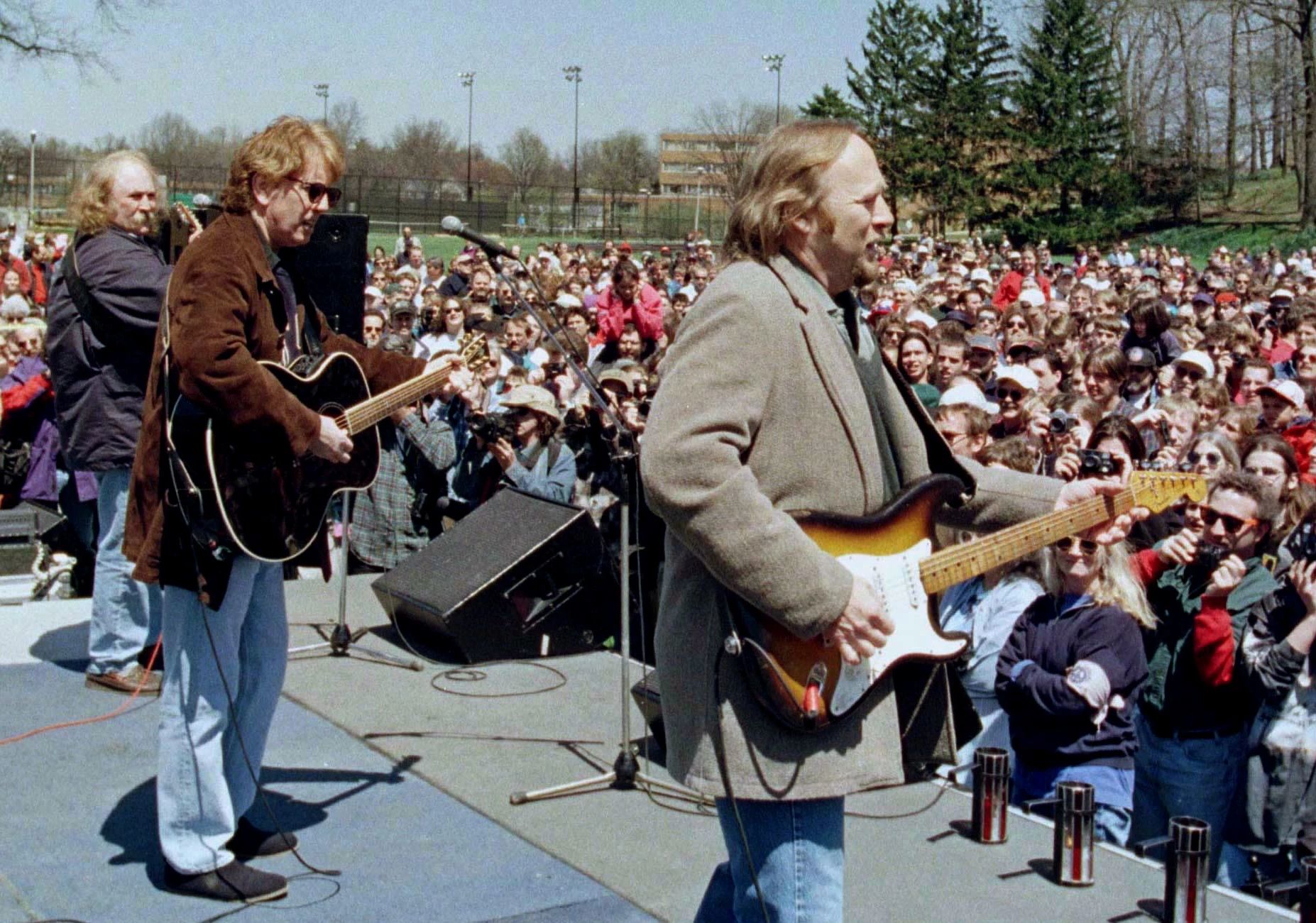 Crosby, Stills, Nash and Young David Crosby, Graham Nash, and Stephen Stills performing on a stage in front of a large crowd