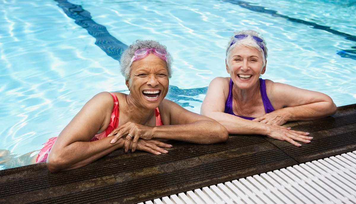  Two smiling mature women in a pool