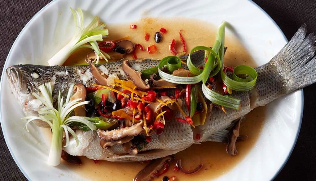 Steamed fish with black bean sauce A close-up view of steamed fish with black bean sauce on a plate