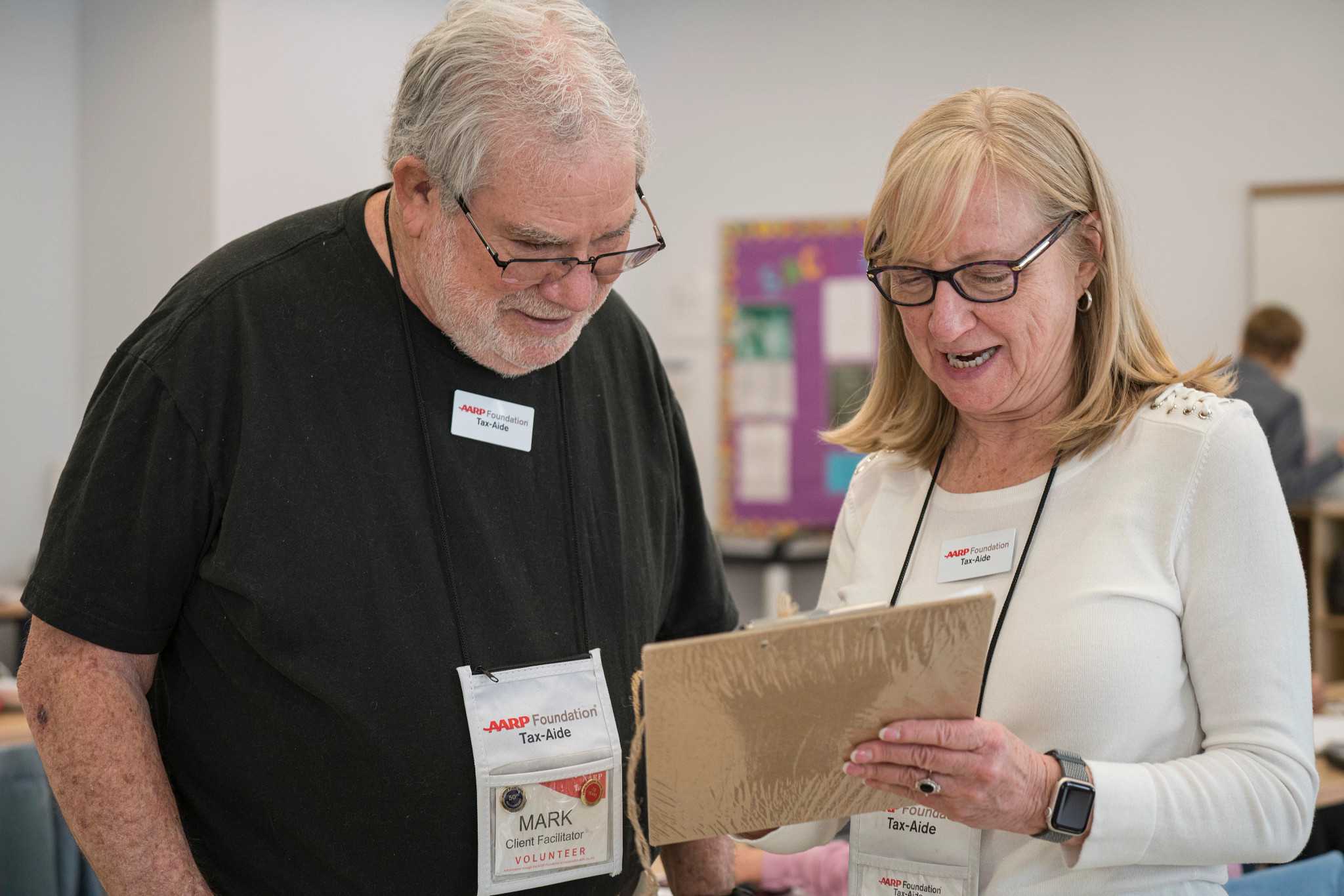 two people looking at a clipboard