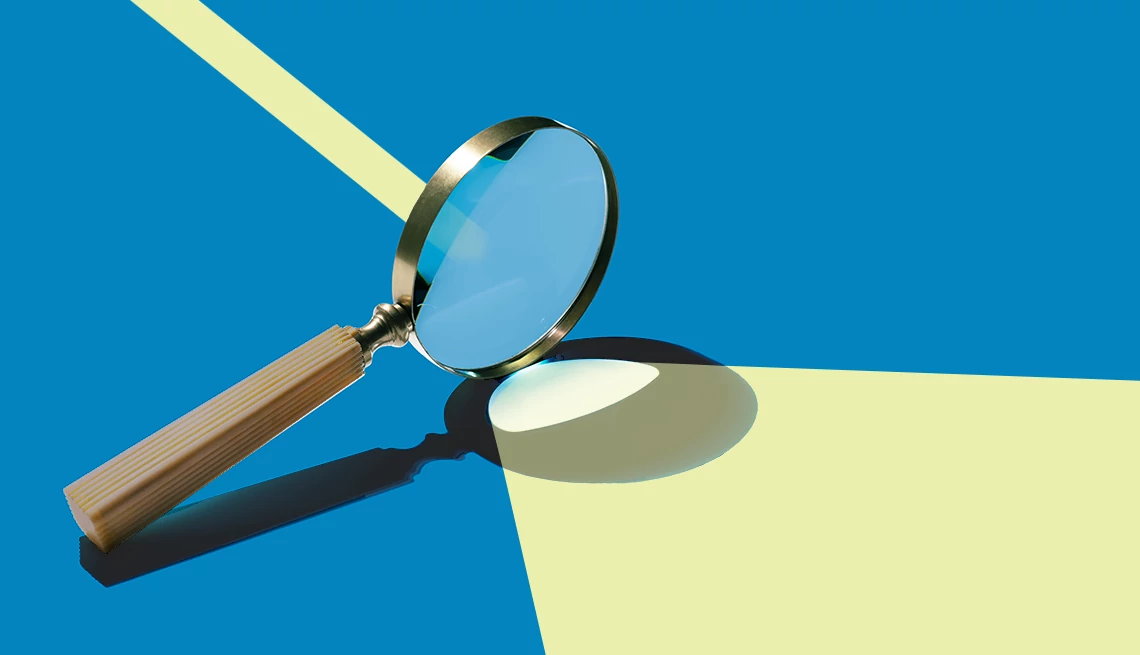 Magnifying Glass Focusing Sunlight on Blue Colored Background High Angle View.