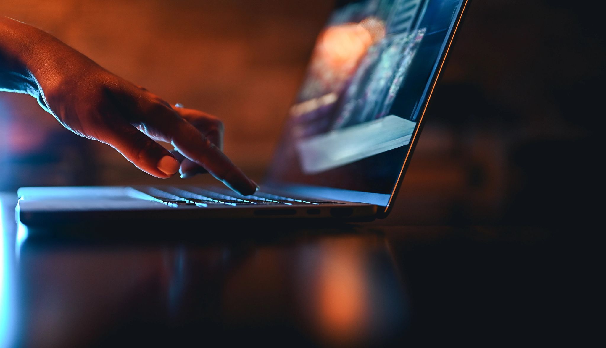 human finger touching laptop keyboard human finger touching laptop keyboard