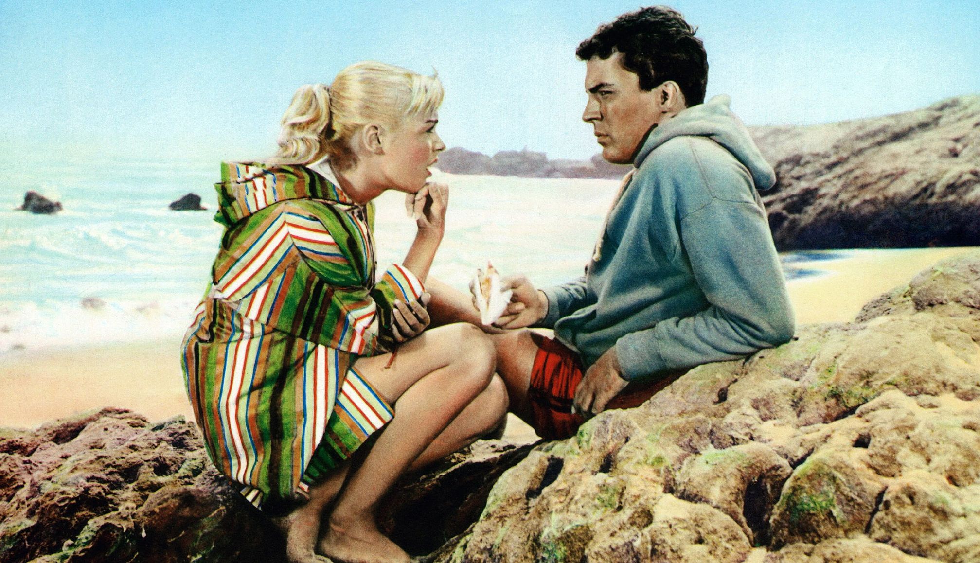 Sandra Dee and James Darren in Gidget Sandra Dee and James Darren sitting in the sand at a beach in the film Gidget