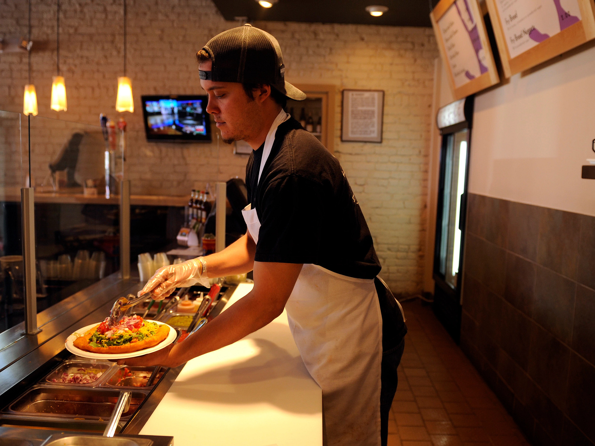 Ben Jacobs assembling a plate of food at his restaurant Tocabe in Denver