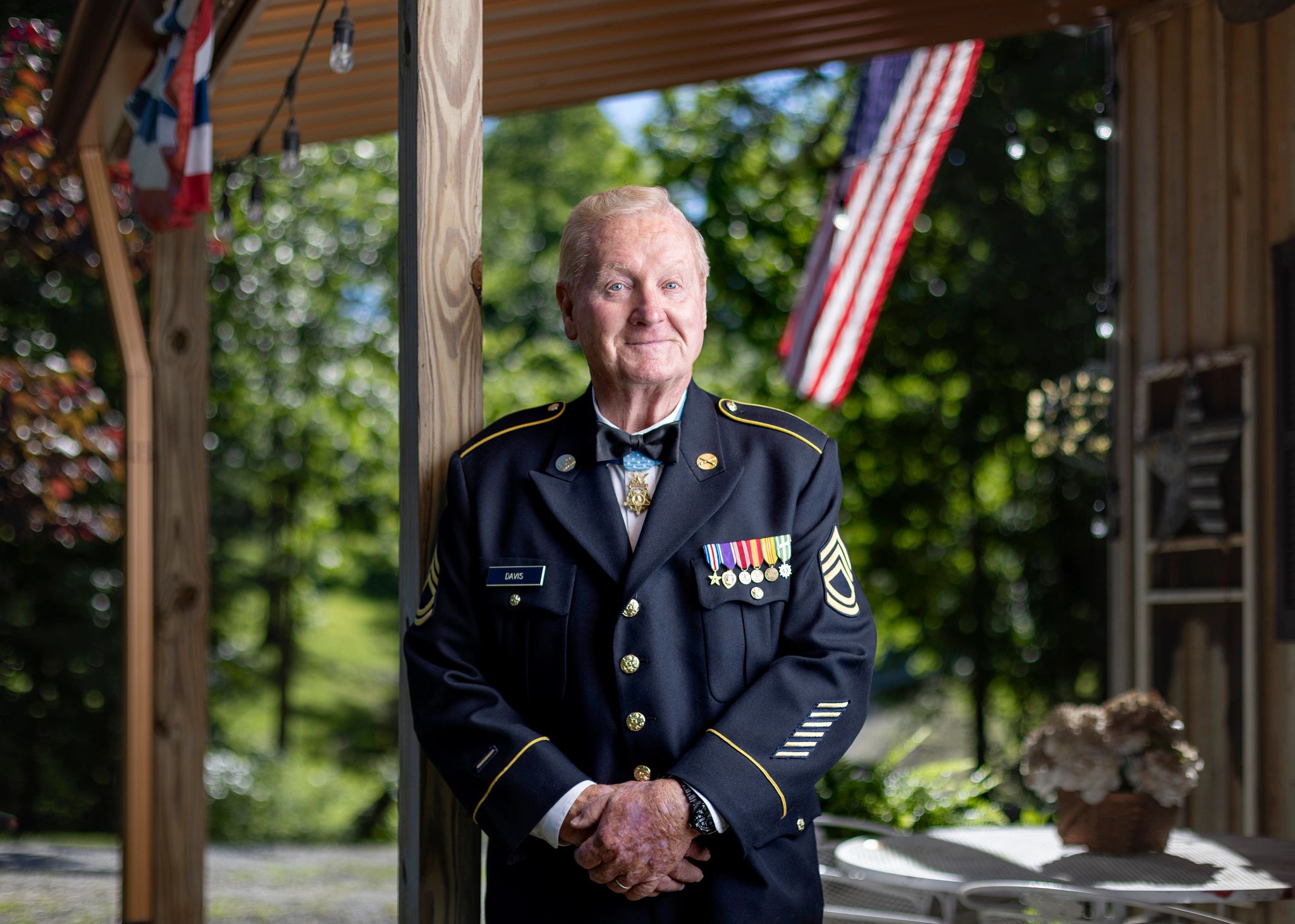 Sammy Lee Davis sammy lee davis, in a military dress uniform with medals pinned to the lapel, stands outside his home.