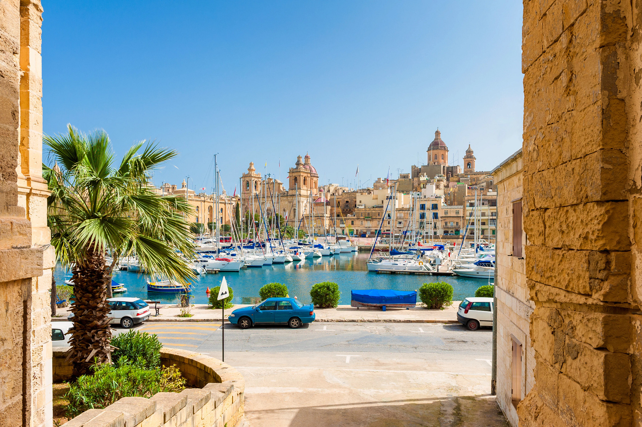 a harbor in birgu, malta with yachts and fishing boats