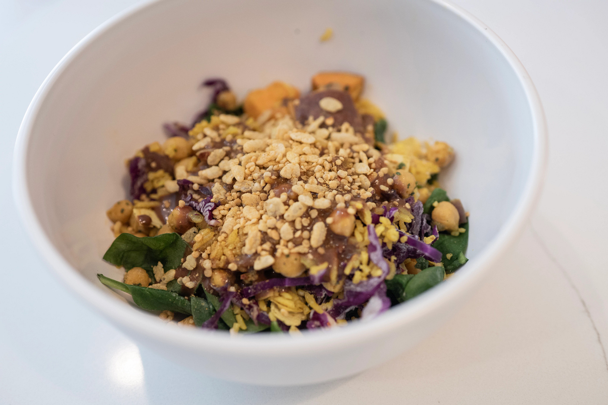 A white bowl full of salad