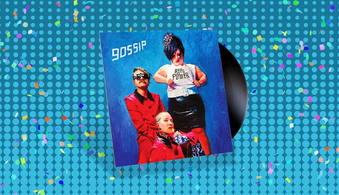 Gossip's “Real Power” Album cover with record sticking out of it and the word gossip and three people, one wearing shirt that says real power, on cover; blue background with confetti on it
