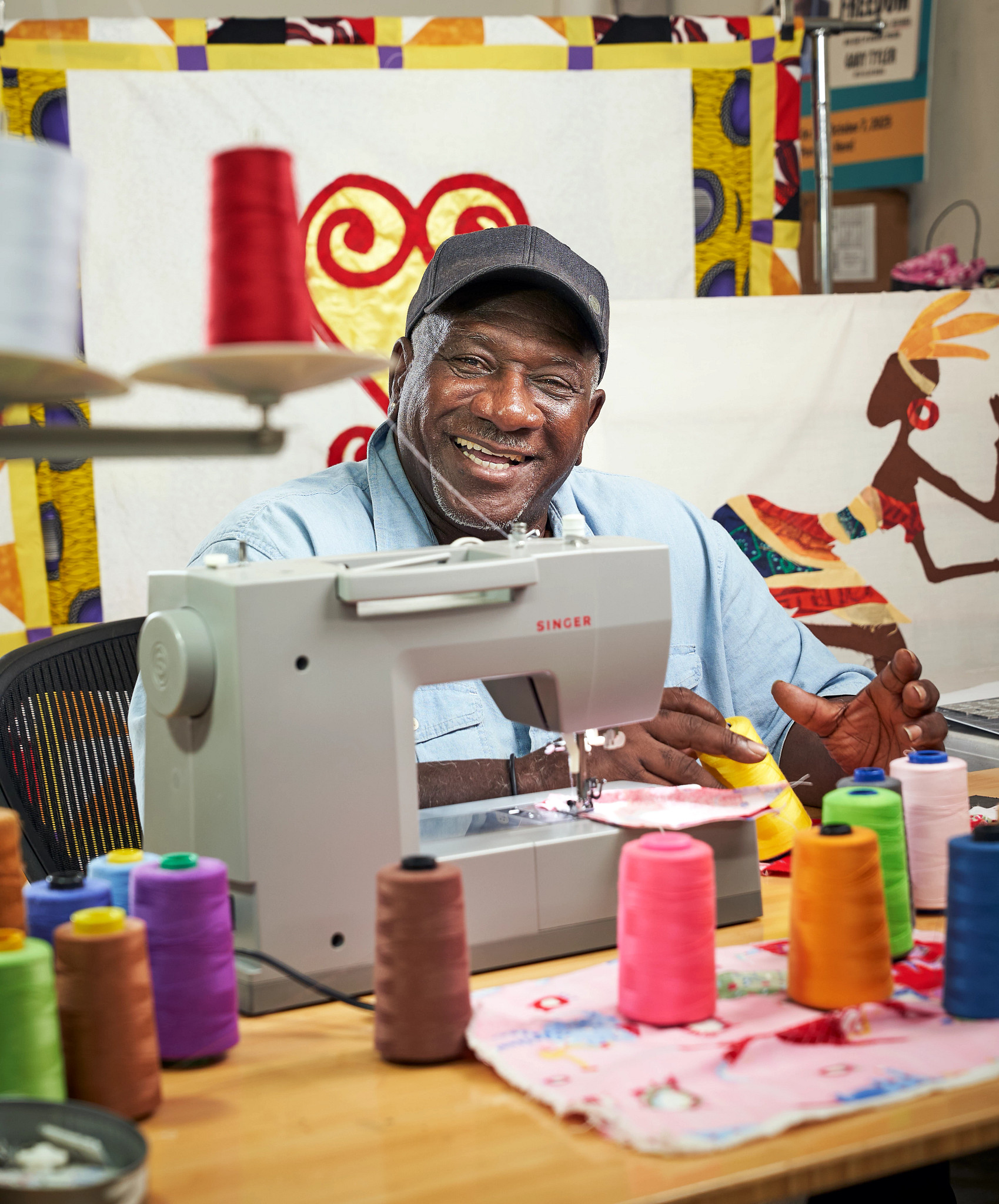 a photo shows Gary Tyler and his quilting tools, a sewing machine and yarn