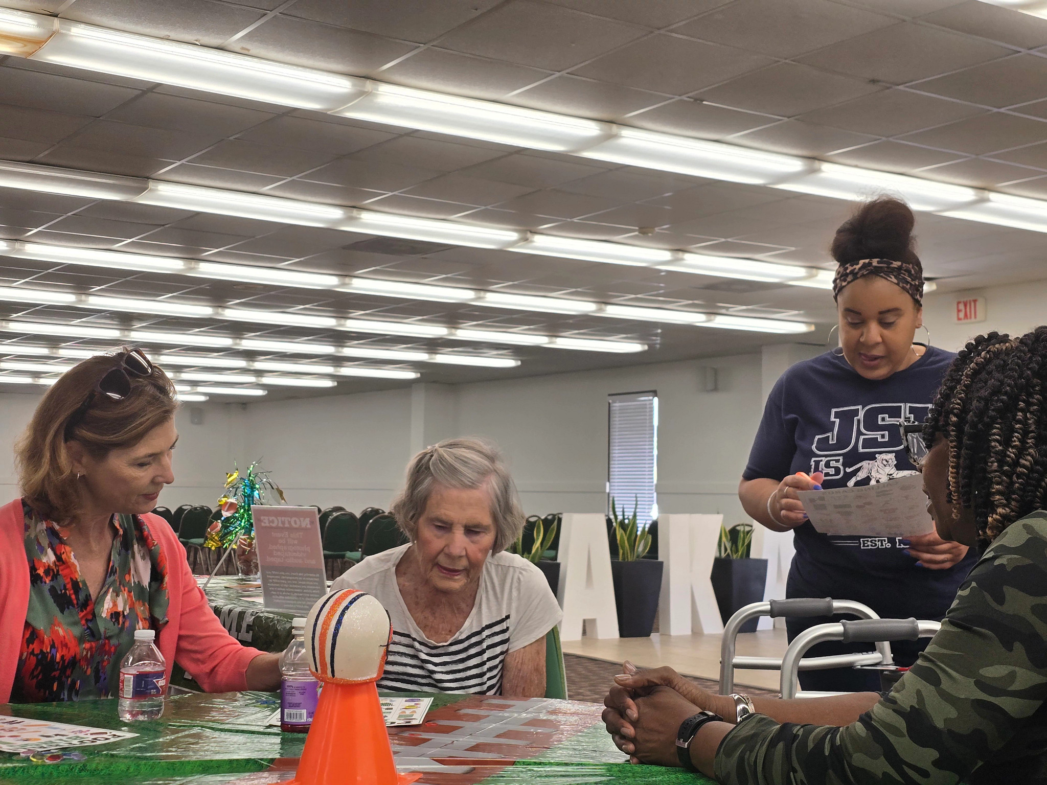 Four women around a table during a bingo event at a memory café gathering