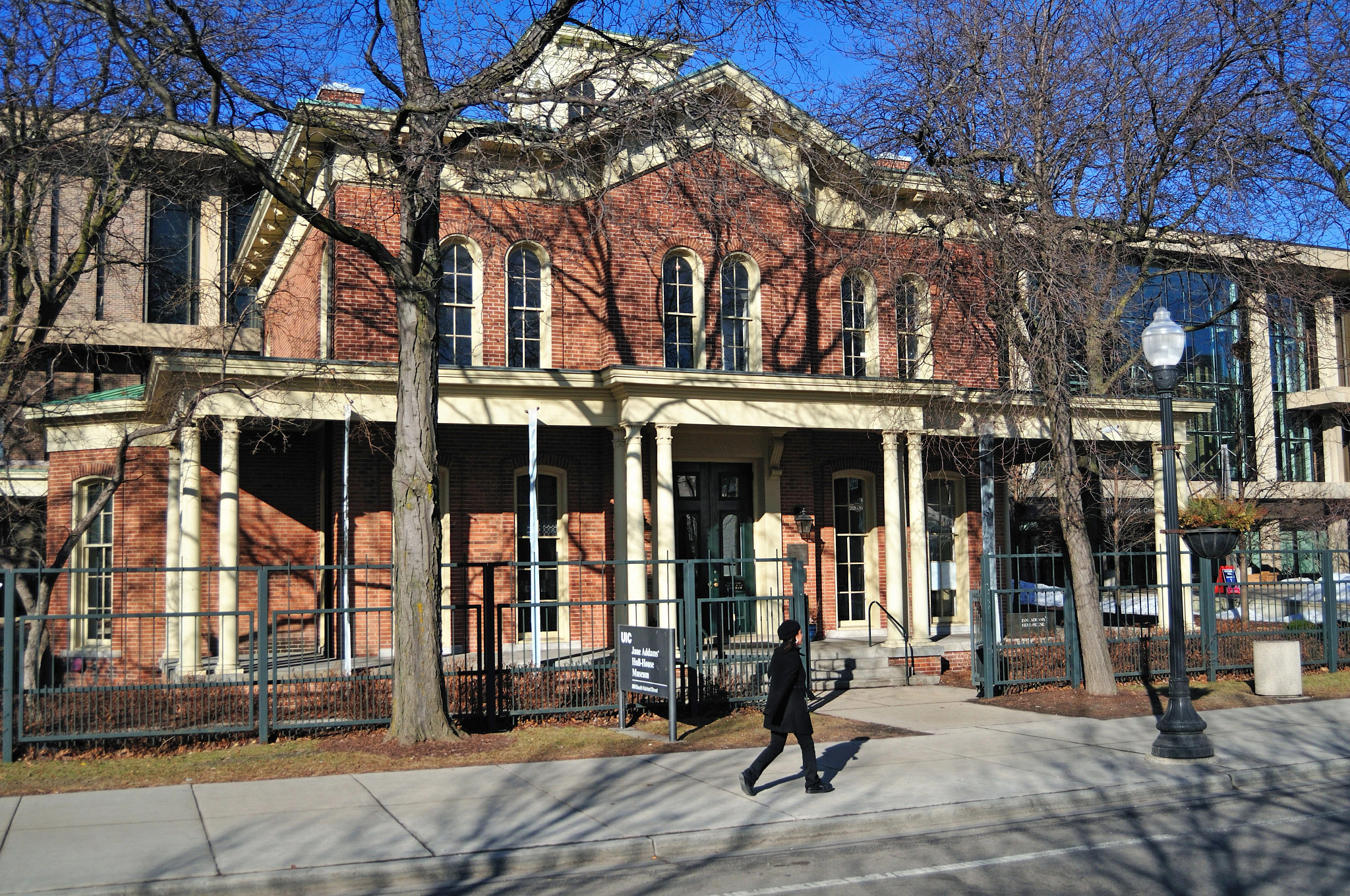 a person walks by a brick building