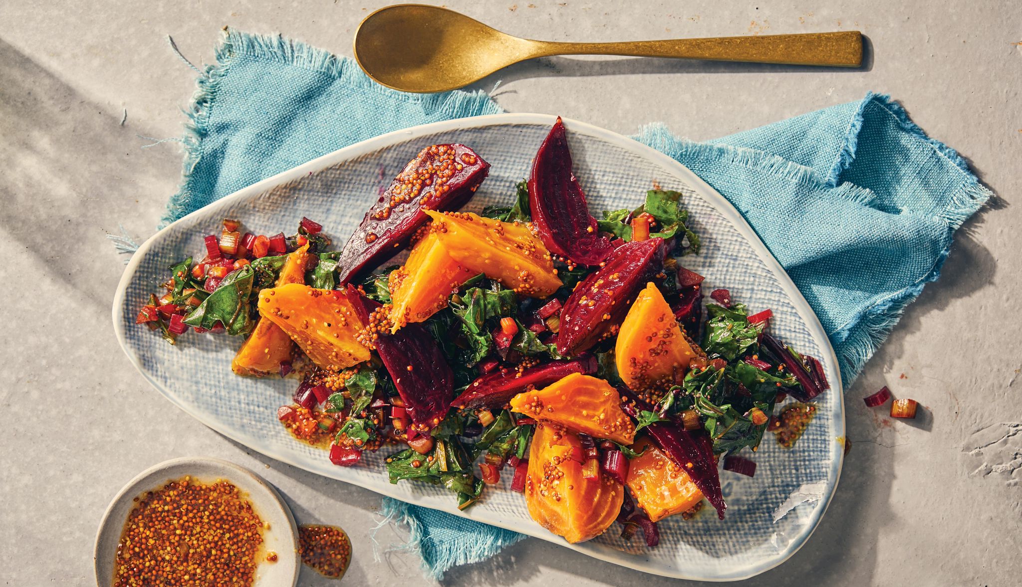 Roasted Beets and Greens Golden and red beets, greens and dressing on dish