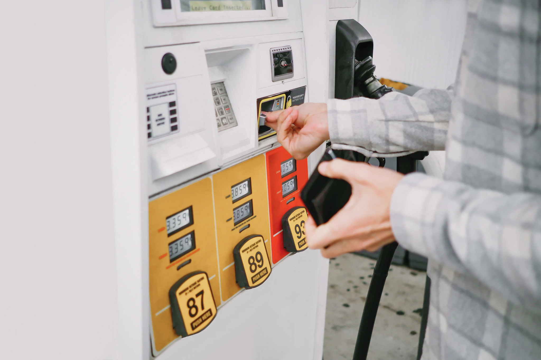 Close-up of unrecognizable white male man purchasing gas at pump