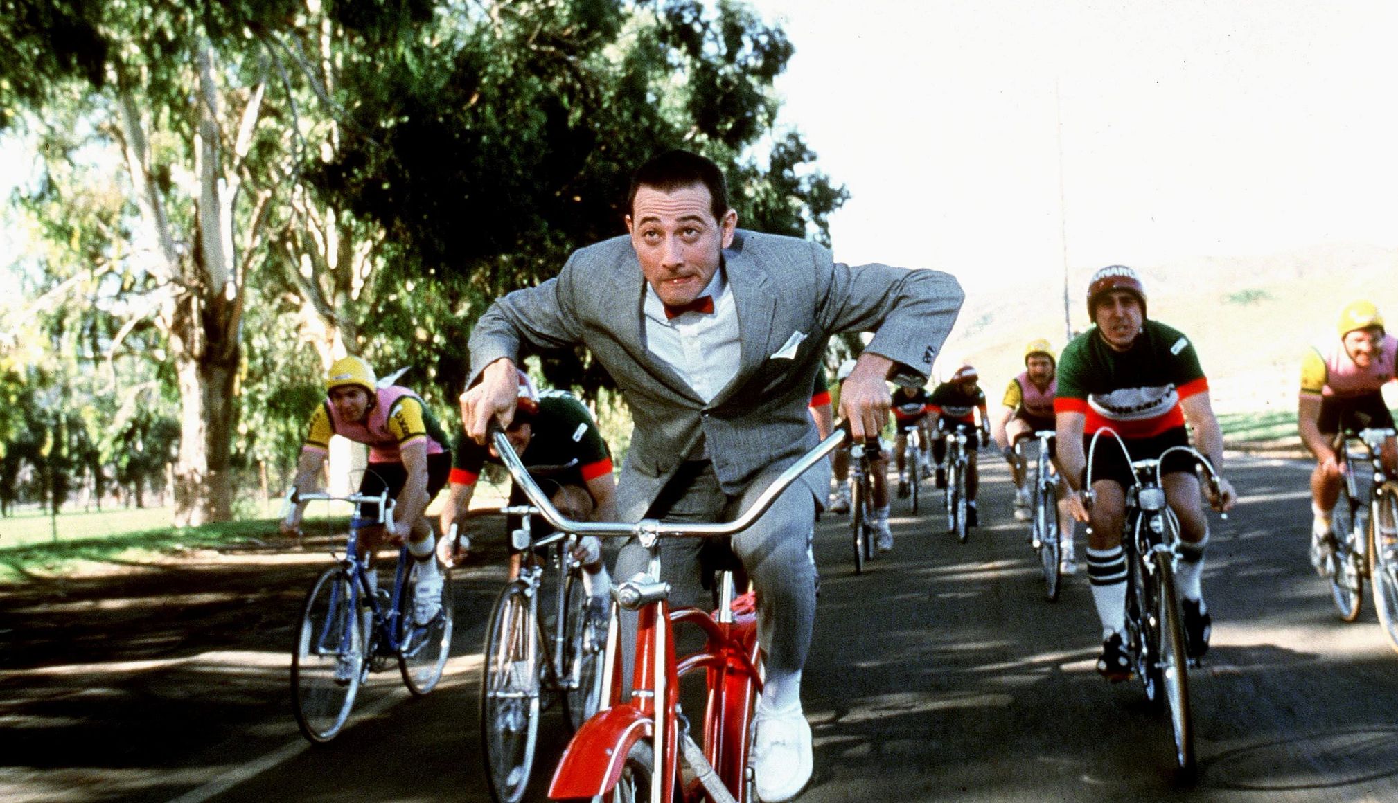 Pee-wee's Big Adventure Turns 40 a scene from Pee-Wee's Big Adventure with the titular character riding on his iconic red bike