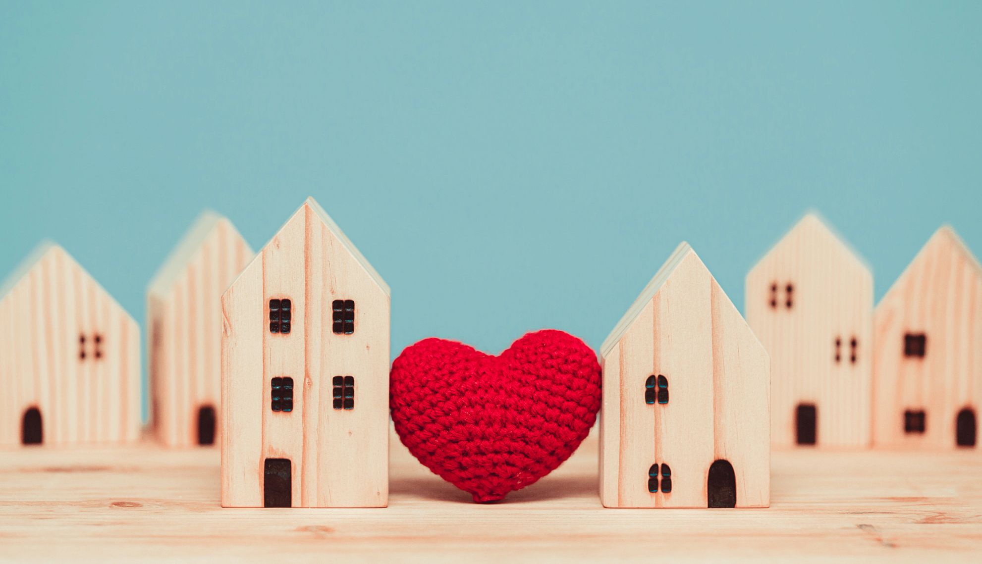 States Expand Family Leave, Financial Help for Caregivers a red heart surrounded by wooden houses
