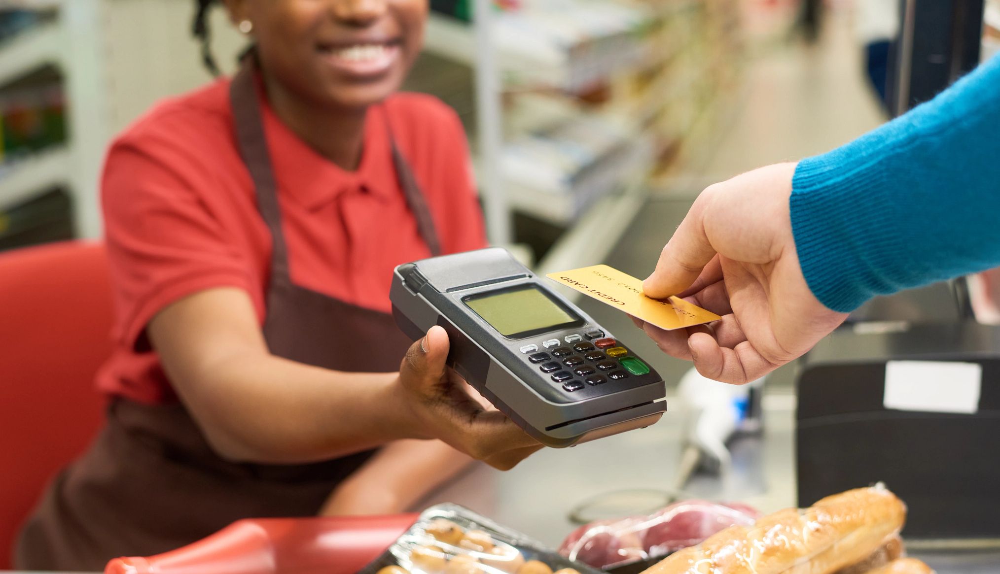 SNAP benefits for older adults a person scans their credit card at a grocery store