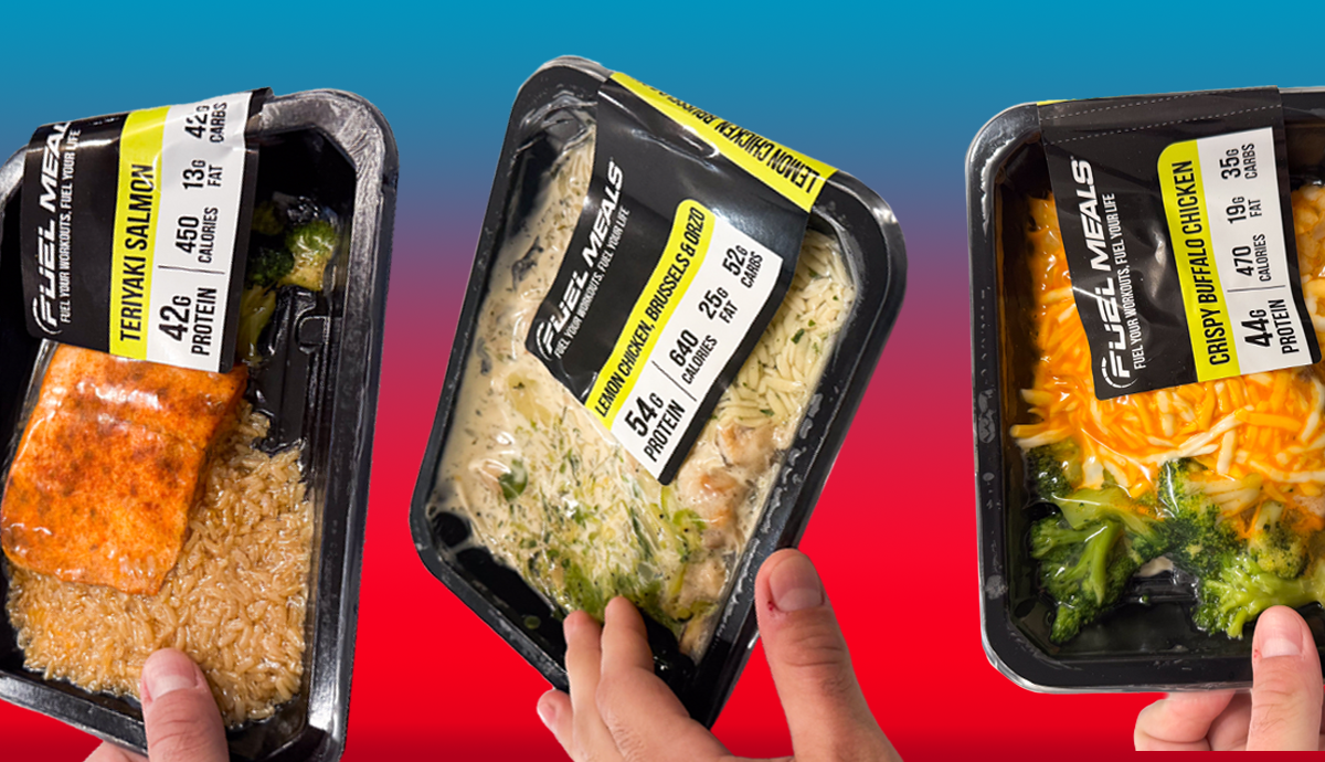 A meal of rice and a salmon fillet vacuum-sealed into a black container with a fuel meals info label on the front