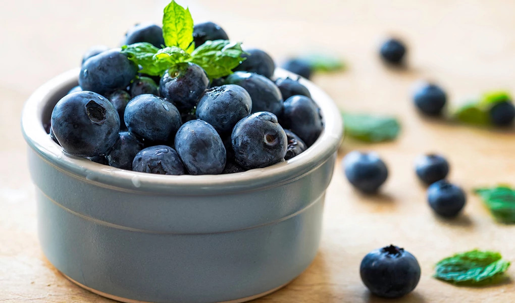 A close-up view of blueberries in a bowl on table