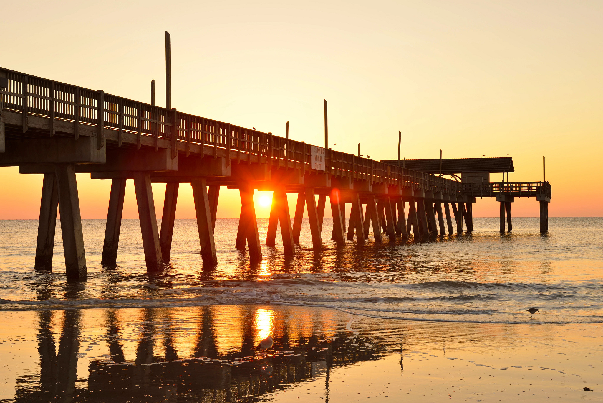 a pier at sunrise