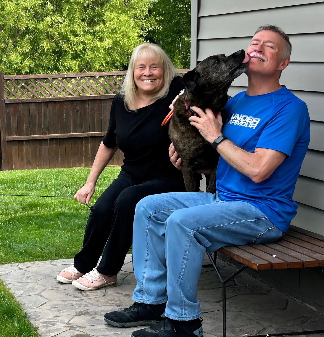 How to Adopt a Dog, The Hard Way A photo shows Deanna and Denny Suggitt in their backyard with Sadie, another of their dogs
