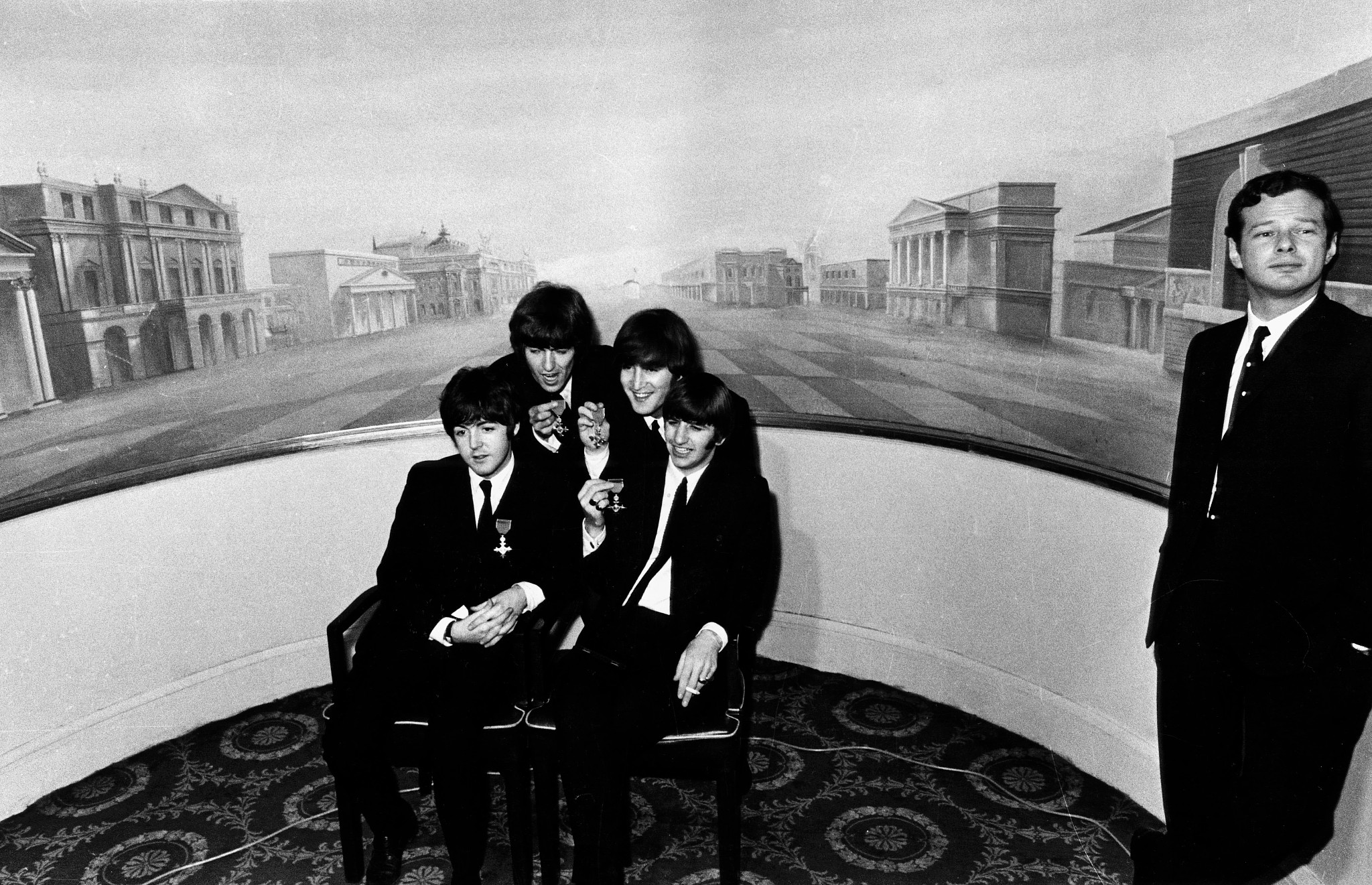 Paul McCartney, George Harrison, John Lennon and Ringo Starr holding their Member of the Order of the British Empire awarded to them at Buckingham Palace