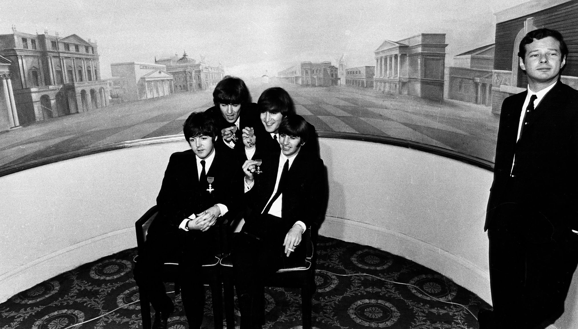Paul McCartney, George Harrison, John Lennon and Ringo Starr holding their Member of the Order of the British Empire awarded to them at Buckingham Palace