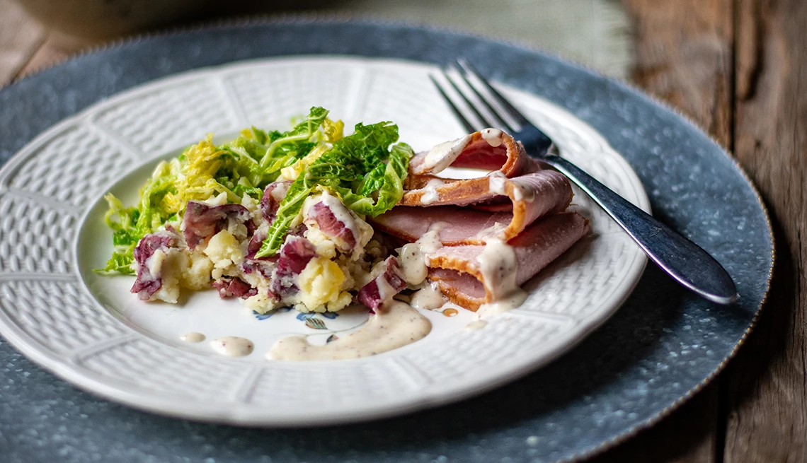 a plate of loin of bacon with crispy cabbage & mustard sauce a plate of loin of bacon with crispy cabbage & mustard sauce