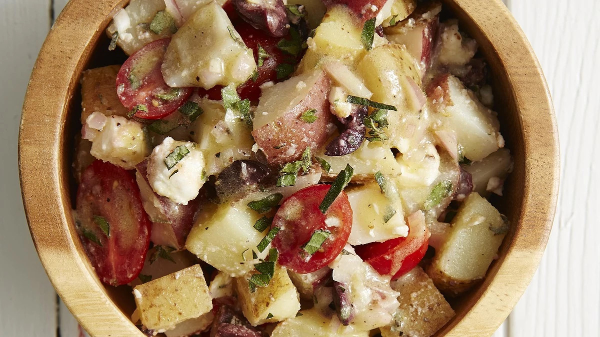 A close-up view of Greek potato salad in a bowl