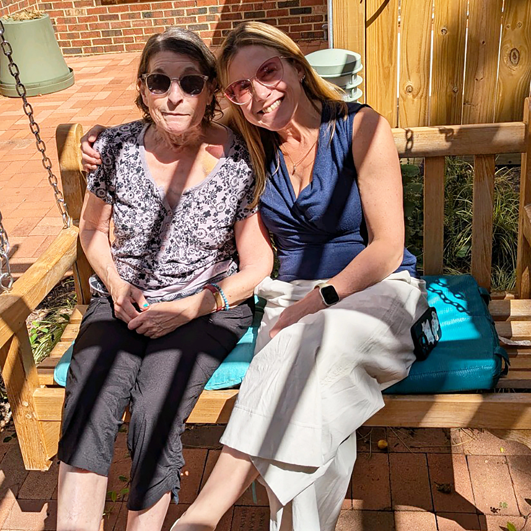 A photo shows writer and surgeon Emily Boss sitting with her mom on a porch swing