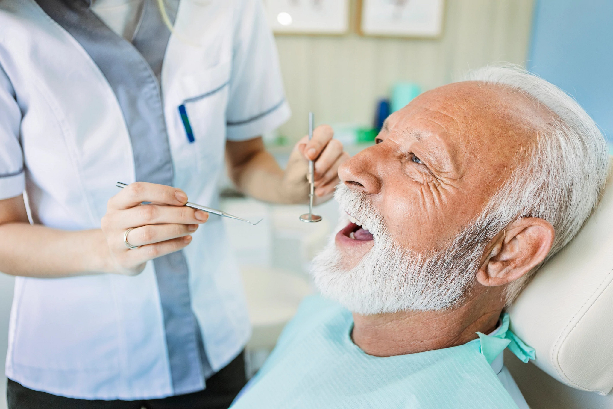 Female dentist with senior patient