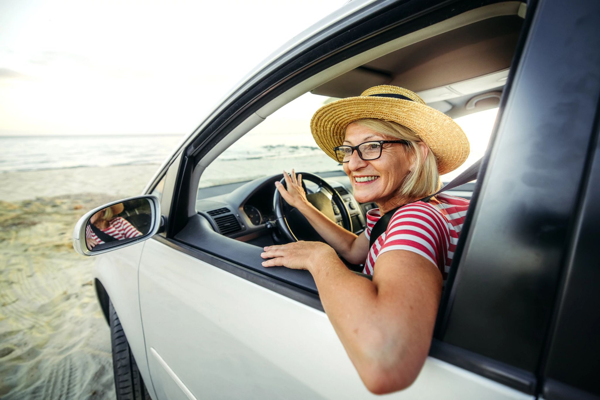 Woman inside vehicle smiling Woman inside vehicle smiling