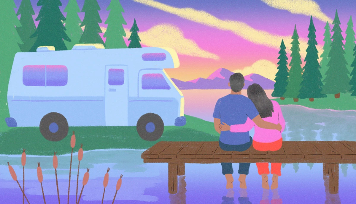a man and woman lean into each other while sitting on a wooden dock with their toes in the water. they are facing a sunset and an RV in the distance.
