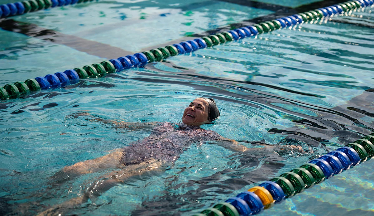 a swimmer is floating in a pool