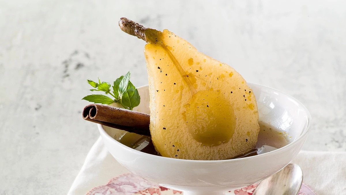 A close-up view of baked pears with marsala-honey syrup